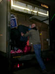 Click on image to see full-sized version Paul packing the last few bags of childrens toys into the truck