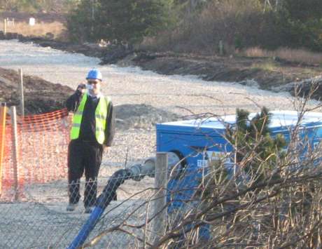 Shell contractor filming people on the road from inside the proposed refinery site