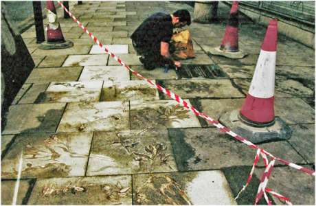 Tom working on the plaque just before the memorial was unveiled in 2004 with the memorial in the foreground